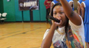 Image courtesy of Danny Digital.  Bria Janelle, the voice of the AEBL gets the crowd hyped for dome basketball action.